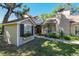 Quaint home exterior with inviting outdoor decor, including a small building and garden at 40600 Louise Rd, Umatilla, FL 32784
