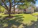 Charming home featuring a sprawling front lawn, mature trees, and inviting curb appeal with a covered front porch at 40600 Louise Rd, Umatilla, FL 32784