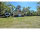 Exterior of garage and workshop with an adjacent trailer, located on a large lot at 40600 Louise Rd, Umatilla, FL 32784