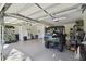 Spacious garage with high ceilings, utility vehicle, and ample storage possibilities at 40600 Louise Rd, Umatilla, FL 32784
