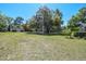 A large lot with a garage, a shed, and scattered trees provide a spacious, rural setting at 40600 Louise Rd, Umatilla, FL 32784