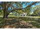 Spacious property featuring garage, storage shed, and mature trees creating a serene environment at 40600 Louise Rd, Umatilla, FL 32784