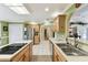 Spacious kitchen with light cabinets, stainless steel appliances, and breakfast bar at 40600 Louise Rd, Umatilla, FL 32784