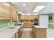 Spacious kitchen features light wood cabinets, modern appliances, and ample counter space at 40600 Louise Rd, Umatilla, FL 32784