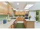 Spacious kitchen features light wood cabinets, modern appliances, and ample counter space at 40600 Louise Rd, Umatilla, FL 32784