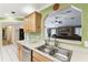 Bright kitchen area with stainless steel sink and open view to living room at 40600 Louise Rd, Umatilla, FL 32784