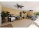 Spacious screened lanai offers ample seating, ceiling fans, and a stainless steel grill at 40600 Louise Rd, Umatilla, FL 32784
