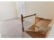 Cozy landing area, carpeted, with a window and wooden railings on the staircase at 40600 Louise Rd, Umatilla, FL 32784