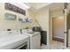 A well-organized laundry room includes a washer, dryer, storage shelves, and window at 40600 Louise Rd, Umatilla, FL 32784