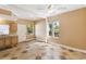 Spacious living room featuring tile flooring, bright windows, and convenient access to the kitchenette at 40600 Louise Rd, Umatilla, FL 32784