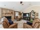 Living room featuring comfortable seating, a brick fireplace, and a flat-screen TV at 40600 Louise Rd, Umatilla, FL 32784