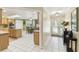 Bright, tiled living room with dining space and entrance foyer with console table at 40600 Louise Rd, Umatilla, FL 32784
