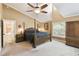 Bright main bedroom with vaulted ceiling, ceiling fan and access to the ensuite bathroom at 40600 Louise Rd, Umatilla, FL 32784