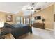 Bright main bedroom features vaulted ceiling, ceiling fan, dual windows and hardwood furniture at 40600 Louise Rd, Umatilla, FL 32784