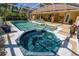 Beautiful pool and jacuzzi with tropical greenery and a screened enclosure at 40600 Louise Rd, Umatilla, FL 32784
