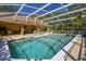 Stunning screened pool area with a jacuzzi and a covered patio, perfect for outdoor living at 40600 Louise Rd, Umatilla, FL 32784