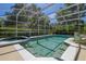 Sparkling pool and jacuzzi with screened enclosure, enhanced by lush landscaping at 40600 Louise Rd, Umatilla, FL 32784