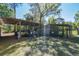 Wood shed with a covered area, a fence, and various supplies around the structure at 40600 Louise Rd, Umatilla, FL 32784