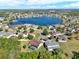 Beautiful aerial view of a community surrounding a serene lake under a bright sky at 4393 S Devon Ct, Kissimmee, FL 34746