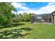 Secluded backyard boasts a screened-in pool, blending seamlessly with the surrounding natural landscape at 4393 S Devon Ct, Kissimmee, FL 34746