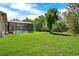 Lush backyard with mature trees and a screened-in pool, ideal for privacy at 4393 S Devon Ct, Kissimmee, FL 34746
