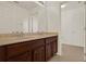 Bathroom featuring a double vanity with wood cabinets and a large mirror at 4393 S Devon Ct, Kissimmee, FL 34746