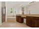 Bathroom featuring dual vanities and sinks, tiled floor, and separate tub at 4393 S Devon Ct, Kissimmee, FL 34746