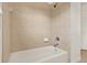 Bright bathroom with tiled shower-tub combo with white fixtures and chrome hardware at 4393 S Devon Ct, Kissimmee, FL 34746