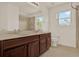 Bathroom featuring a double vanity with granite countertop, tile floors and a shower with glass door at 4393 S Devon Ct, Kissimmee, FL 34746