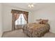 This carpeted bedroom features a view of a sliding glass door at 4393 S Devon Ct, Kissimmee, FL 34746