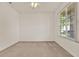 Bright bedroom featuring neutral carpet, a ceiling fan, and a large window at 4393 S Devon Ct, Kissimmee, FL 34746