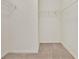 Spacious walk-in closet with neutral carpet and built-in wire shelving at 4393 S Devon Ct, Kissimmee, FL 34746