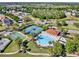 Aerial shot of community amenities, including a pool, tennis courts, and a basketball court, all surrounded by lush landscaping at 4393 S Devon Ct, Kissimmee, FL 34746