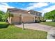 Charming two-story home with a three-car garage, brick-paved driveway, and lush landscaping at 4393 S Devon Ct, Kissimmee, FL 34746
