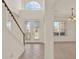 Bright foyer features a staircase, decorative glass front doors, and a high arched window at 4393 S Devon Ct, Kissimmee, FL 34746