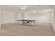 A large game room with ceiling fans and neutral carpet throughout at 4393 S Devon Ct, Kissimmee, FL 34746