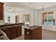 Open kitchen with an island, white appliances, and breakfast bar overlooking pool at 4393 S Devon Ct, Kissimmee, FL 34746