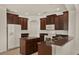 Modern kitchen featuring dark wood cabinetry, stainless appliances, and island at 4393 S Devon Ct, Kissimmee, FL 34746