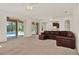 Open living room with plush carpeting, sliding doors to the pool, and neutral paint at 4393 S Devon Ct, Kissimmee, FL 34746
