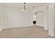 Open living space with neutral carpet, archways, and chandelier at 4393 S Devon Ct, Kissimmee, FL 34746