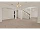 Spacious living area showcasing archways, staircase, and neutral carpet at 4393 S Devon Ct, Kissimmee, FL 34746