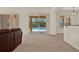 Comfortable living area features views of the backyard pool and access to the outdoor space at 4393 S Devon Ct, Kissimmee, FL 34746