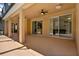 Covered outdoor living area with ceiling fans and multiple sliding glass doors at 4393 S Devon Ct, Kissimmee, FL 34746