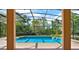 A serene screened-in pool with clear blue water provides a refreshing view and a tranquil retreat at 4393 S Devon Ct, Kissimmee, FL 34746