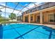 Stunning screened-in pool with sun-drenched patio provides a luxurious outdoor oasis for Gathering and guests at 4393 S Devon Ct, Kissimmee, FL 34746
