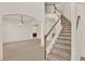 Bright foyer with tiled floors flows into the carpeted living area and features a classic staircase to the second level at 4393 S Devon Ct, Kissimmee, FL 34746