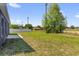 Large, grassy back yard with a concrete patio and white fence at 4761 Sw 142Nd Place Rd, Ocala, FL 34473