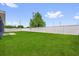 Spacious backyard with lush green grass and a white privacy fence, perfect for outdoor activities at 4761 Sw 142Nd Place Rd, Ocala, FL 34473