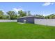 Large backyard with green grass and a privacy fence, perfect for outdoor living at 4761 Sw 142Nd Place Rd, Ocala, FL 34473