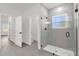 Modern bathroom featuring a glass enclosed shower with black fixtures and window at 4761 Sw 142Nd Place Rd, Ocala, FL 34473